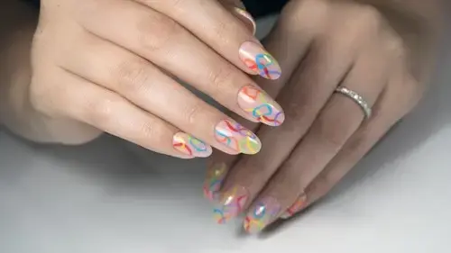 woman's hand with swirl nails