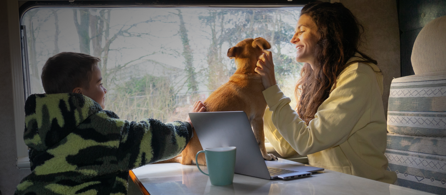 woman with a dog in front of a campervan