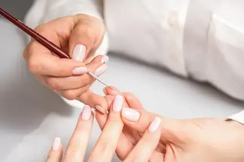 nail tech working on client's french tips