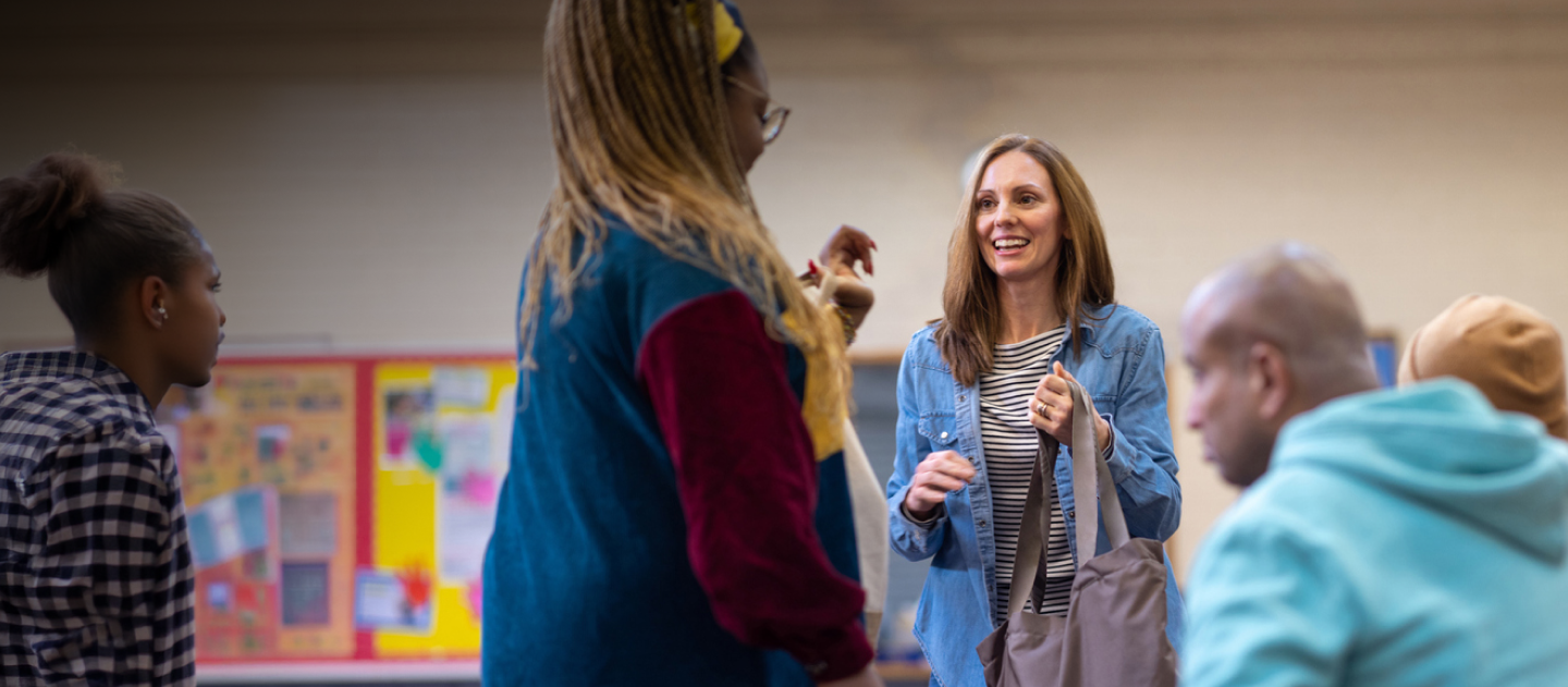 Two people chatting in a village hall