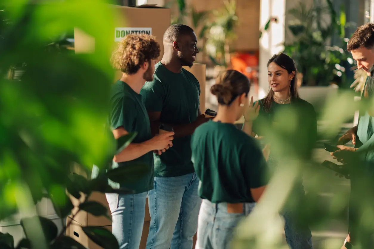 Volunteers stood in a circle having a meeting