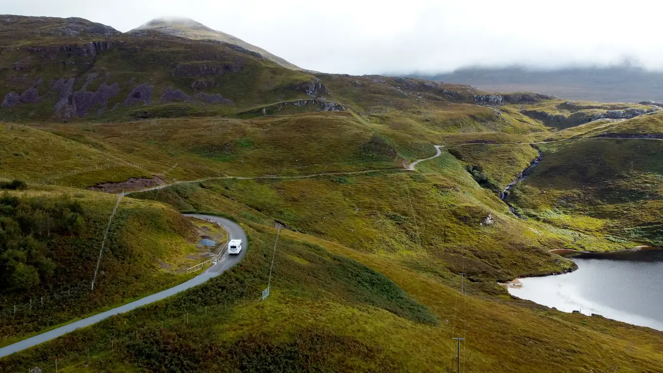 Caravan driving up a windy road