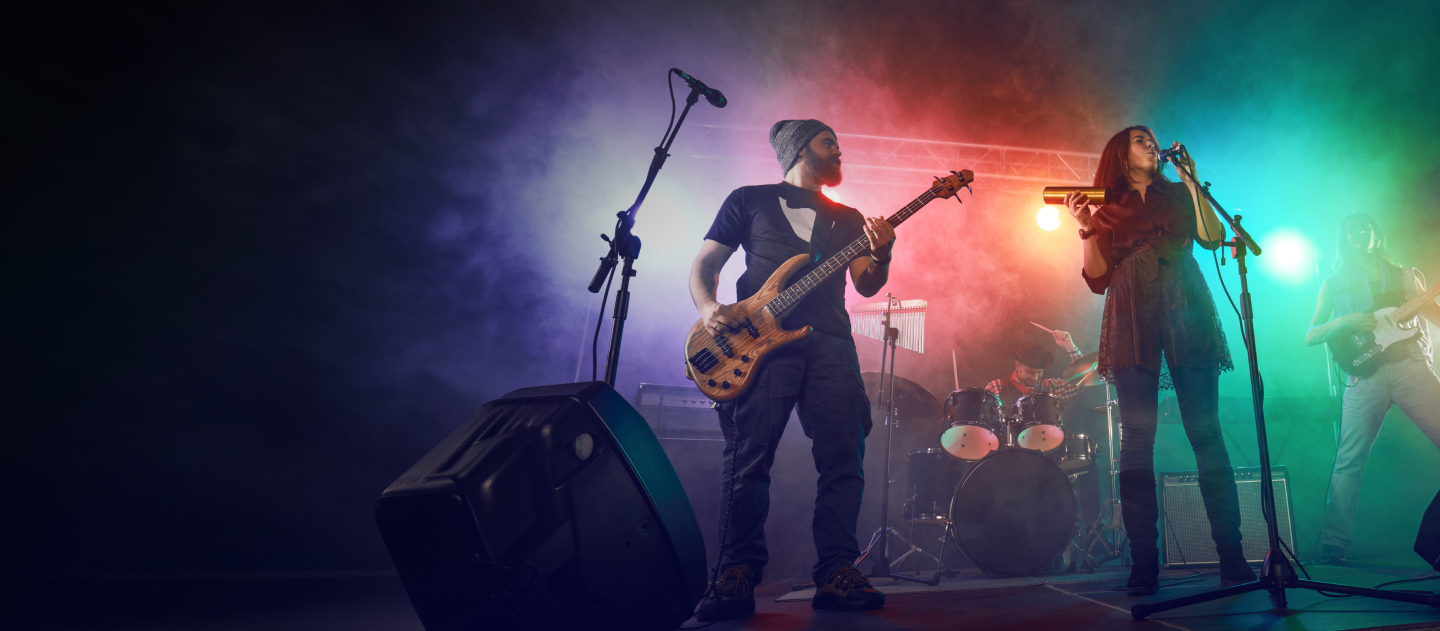 People in band playing their guitars on stage 