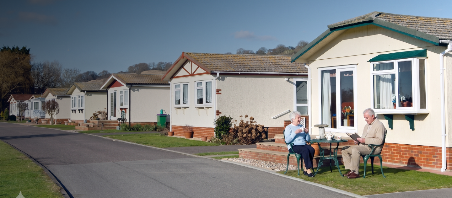 Couple sat outside their park home
