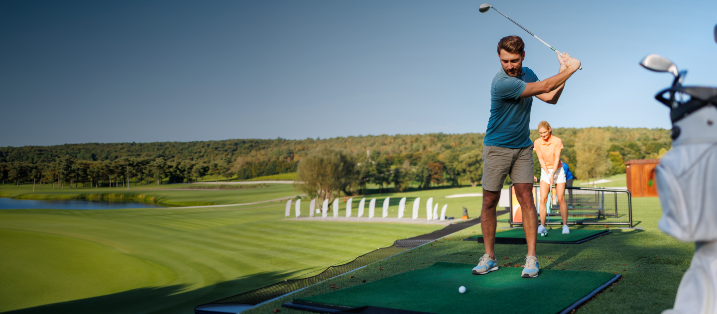 picture of people at driving range hitting shots