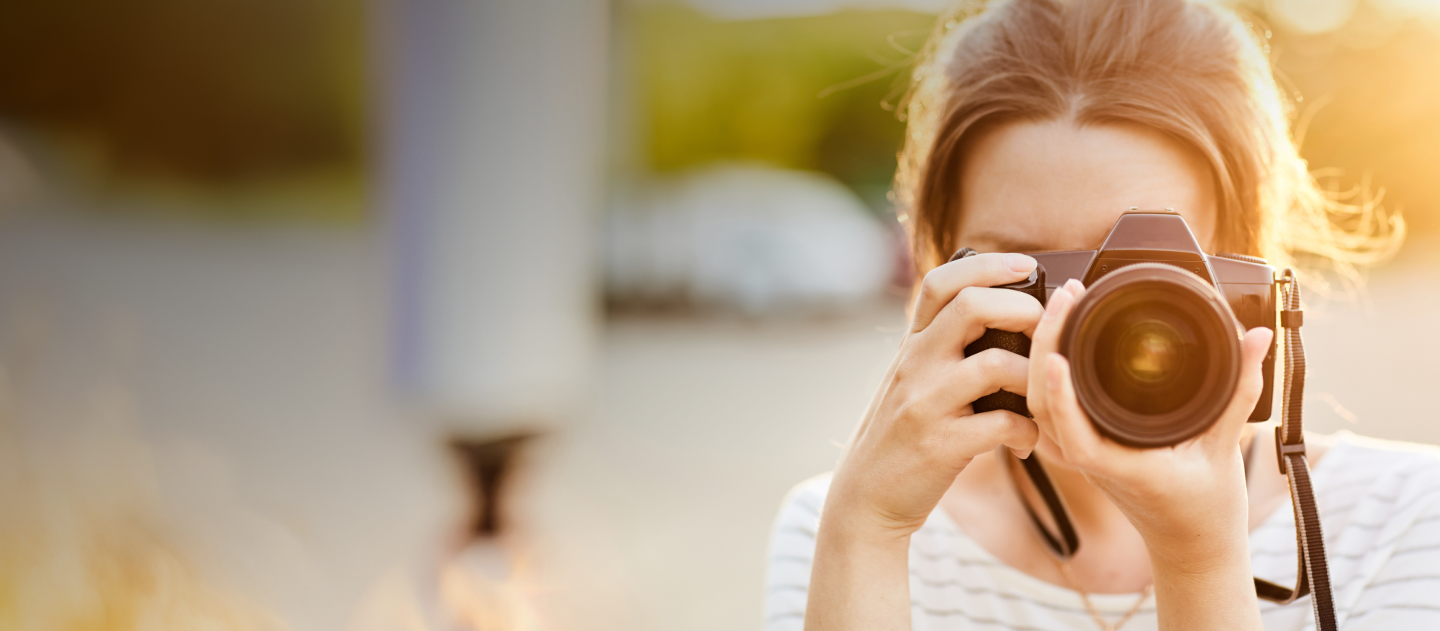 Woman taking a picture with DLSR