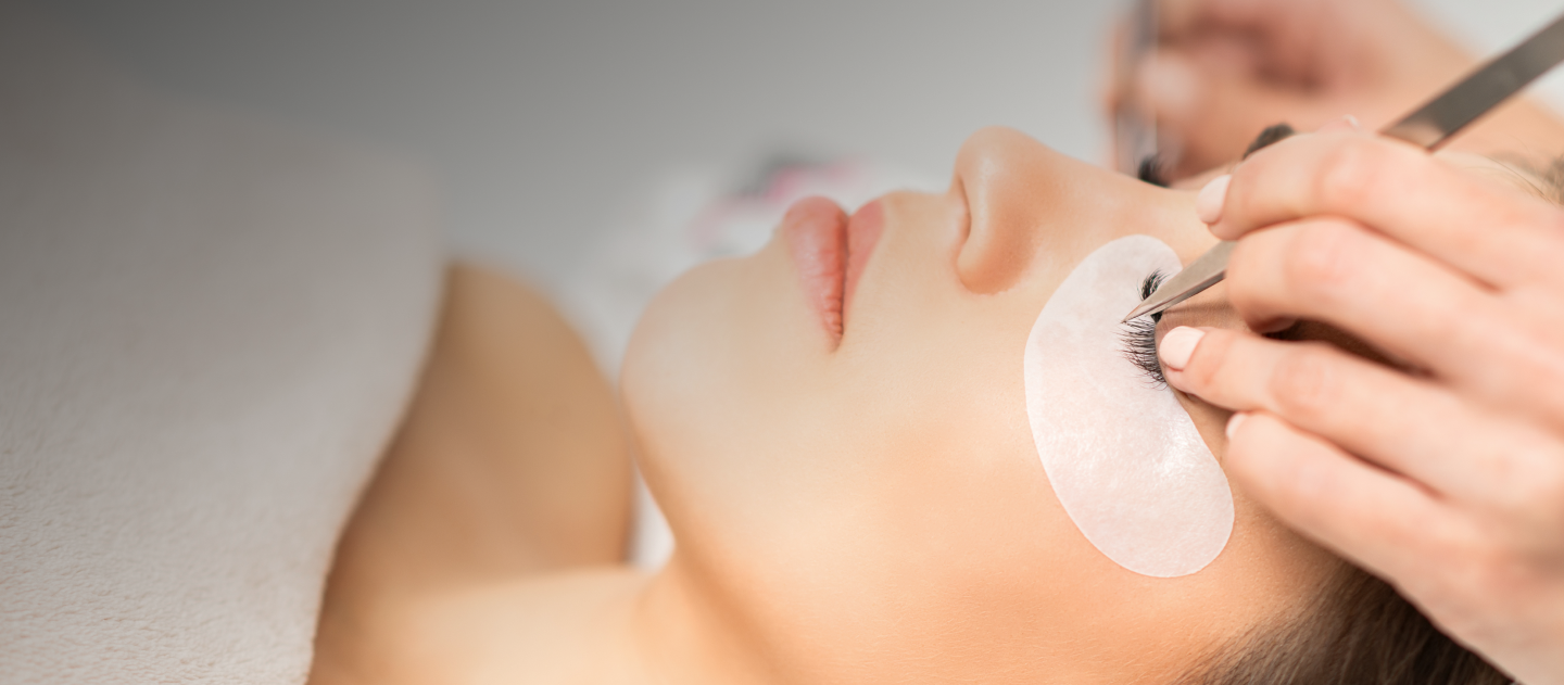 Eyelash technician working on a client's eyelashes