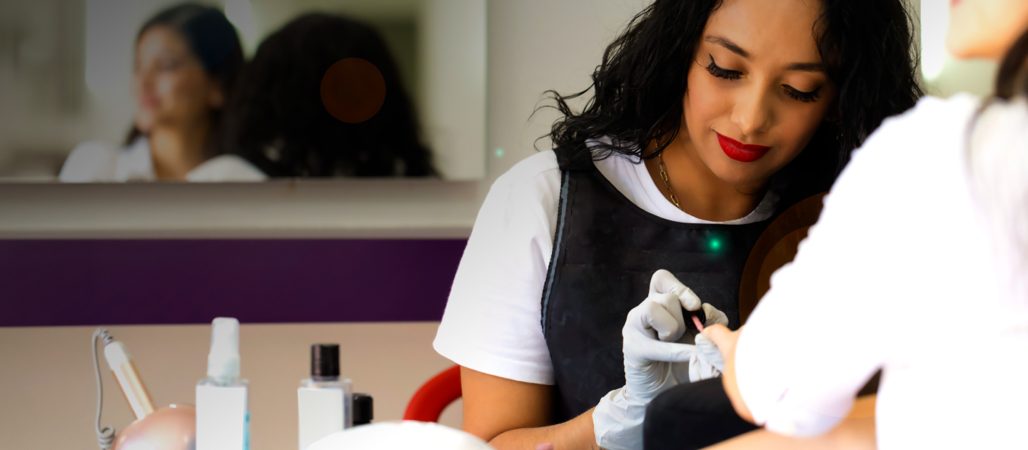 Nail salon owner working on a client's nails