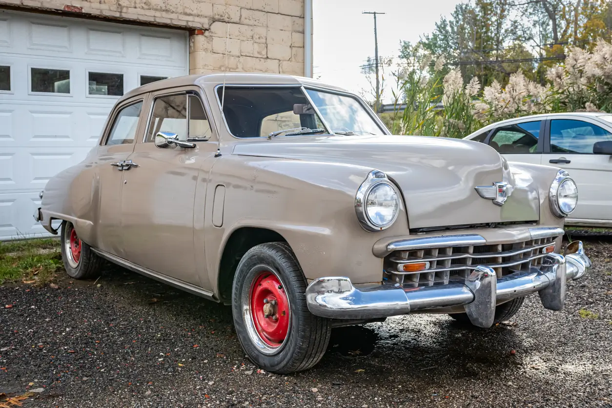 car from the 1940s in front of a garage
